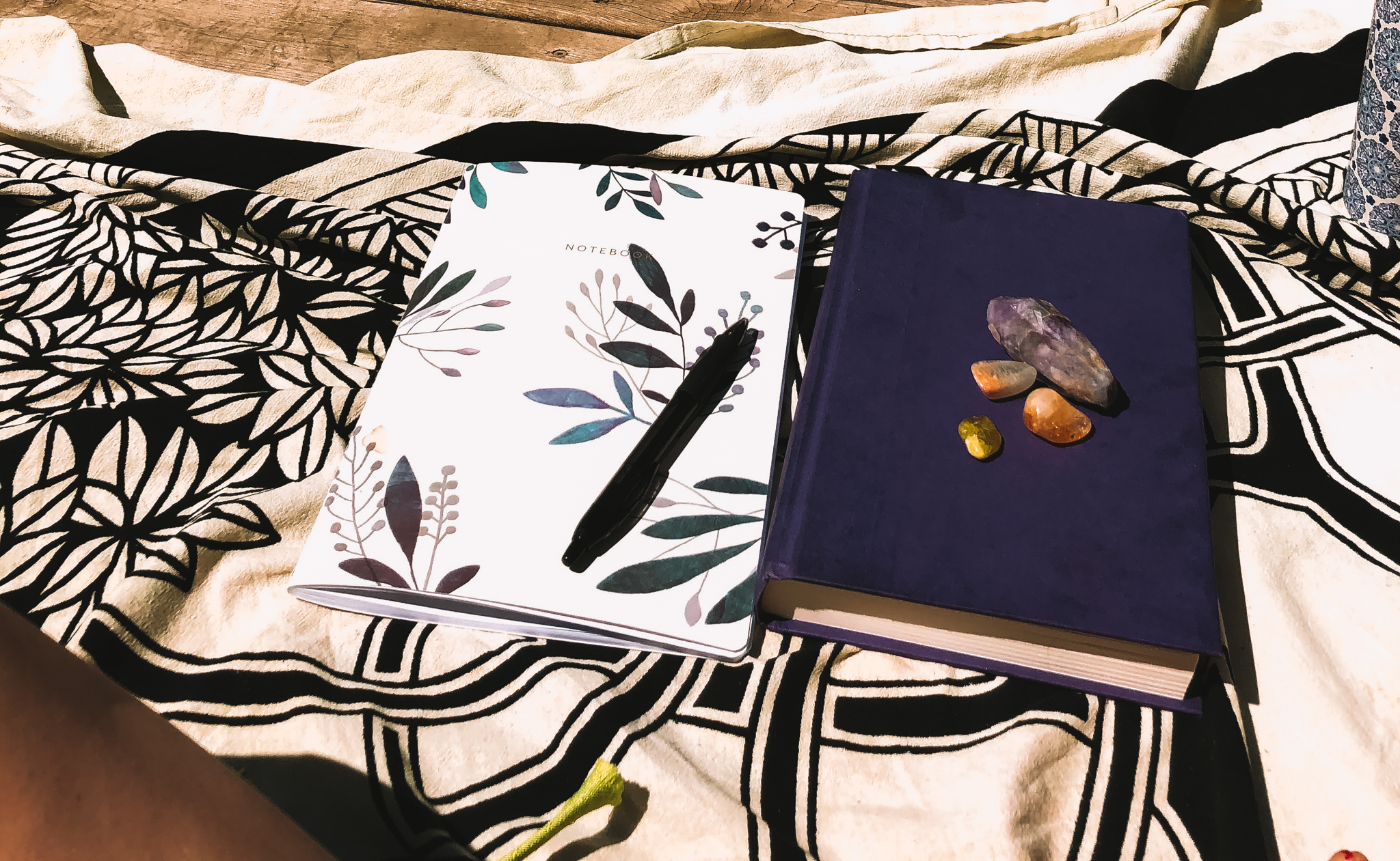 notebook, crystals and book sitting ready to begin the copywriting for creatives process