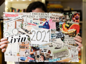 Lauren holds up a vision board that has a series of images, words and phrases that correspond to her vision and goals. This vision board is one of her intentional habits that helps her stay on track in 2022. 