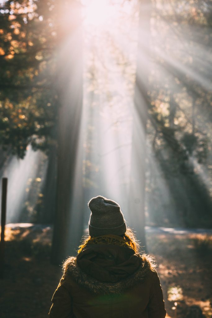 Woman wandering outside in nature to align, connect, motivate and inspire herself 