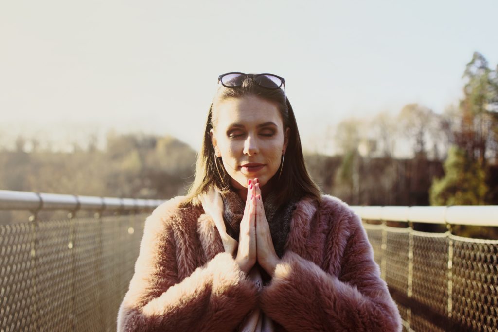 Woman uses the gratitude activity of meditation to tap into her thankfulness 