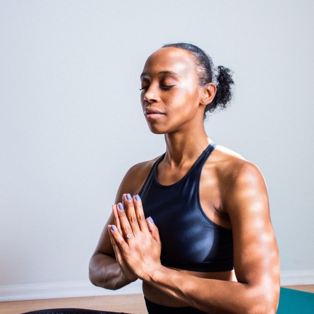 Woman meditating taps into her gratitude mindset with a spiritual approach: meditation