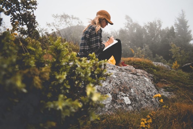 Woman journaling her affirmations to build her new beliefs towards sustainable habits 