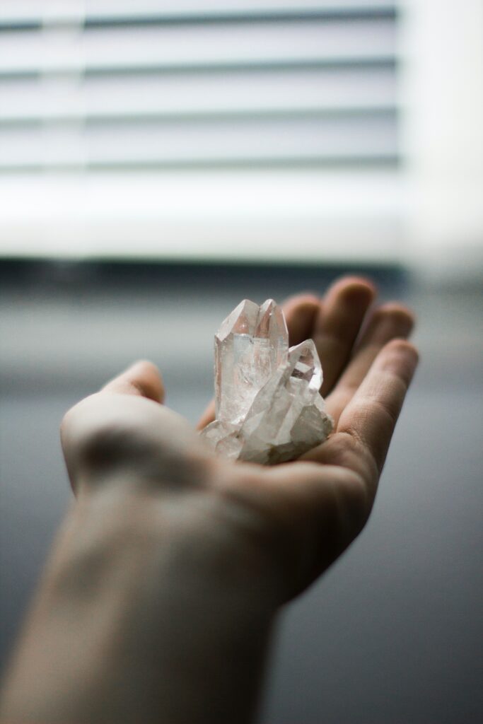 woman using a crystal to anchor a memory or good emotion 