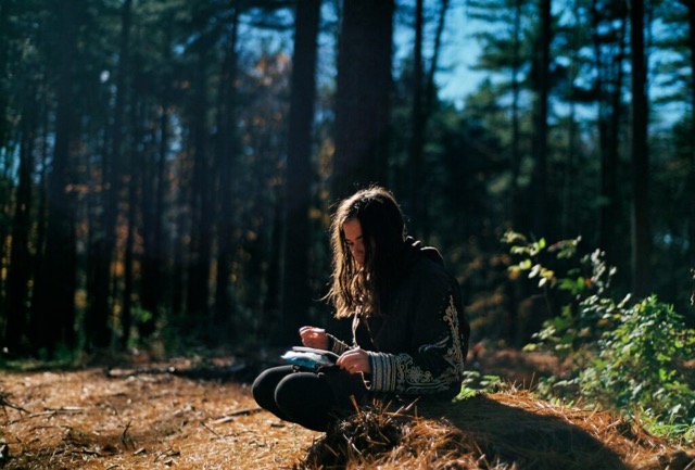 woman writing in a gratitude journal 