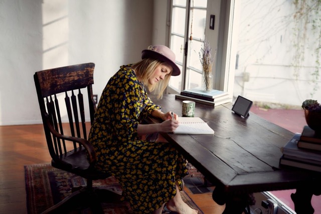 woman journaling to write out and question her beliefs and gather evidence 