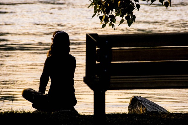 woman sitting in meditation during period of trauma healing 