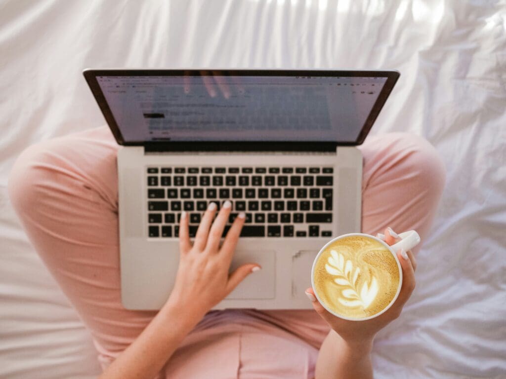 Woman DIY copywriting with her morning coffee for her small business 