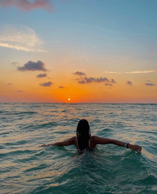 Woman basking in what she enjoys, knowing its a portal to discovering your soul's purpose